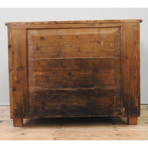 33 - A 19TH CENTURY CONTINENTAL WAXED PINE SIDE CUPBOARD, of simplistic form, with panelled doors enclosi... 