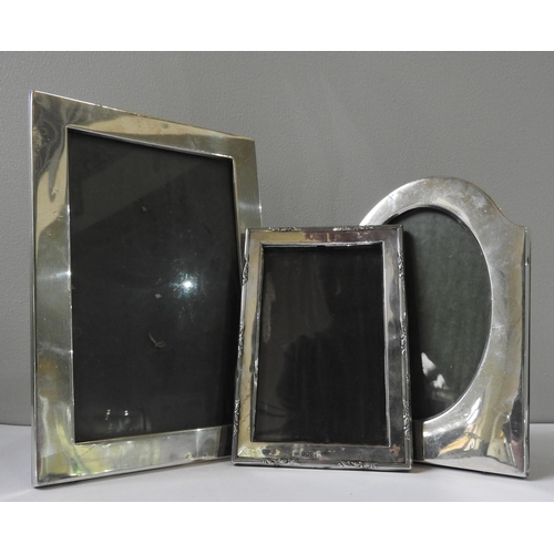 497 - THREE SILVER MOUNTED PICTURE FRAMES, the lot comprising of:an oval silver picture frame by Charles G... 