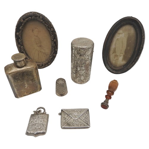 472 - TWO OVAL SILVER PICTURE FRAMES, SILVER SCENT FLASK, SILVER CASED SCENT BOTTLE AND TRINKETS, the trin... 