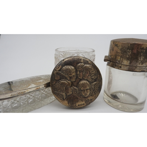 473 - A GLASS JAR WITH REPOUSSE DECORATED SILVER LID AND TWELVE OTHER GLASS CONTAINERS WITH SILVER LIDS, c... 