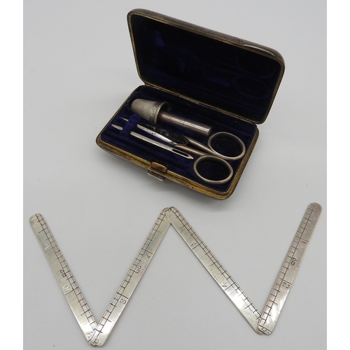 468 - A SILVER NECCESSAIRE AND TWO OVAL SILVER PICTURE FRAMES, the neccessaire containing folding rule, th... 