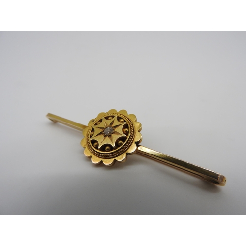 455 - A LATE 19TH CENTURY GOLD ETRUSCAN REVIVAL BROOCH, with a single star set diamond in the centre of a ... 