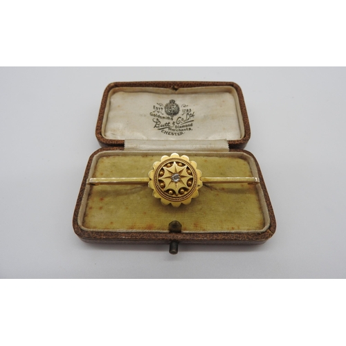 455 - A LATE 19TH CENTURY GOLD ETRUSCAN REVIVAL BROOCH, with a single star set diamond in the centre of a ... 