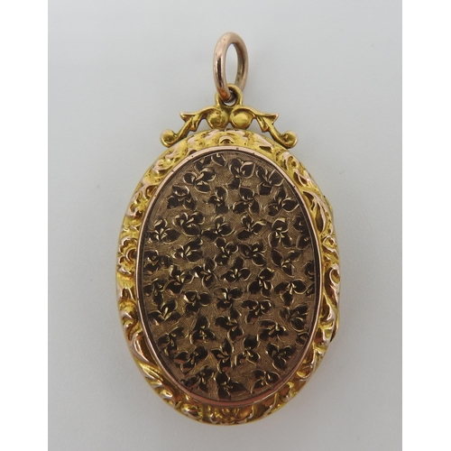 448 - A 19TH CENTURY GOLD FILLED OVAL LOCKET, with engraved profuse floral decoration and shield cartouche... 