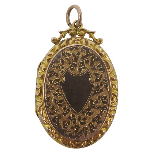 448 - A 19TH CENTURY GOLD FILLED OVAL LOCKET, with engraved profuse floral decoration and shield cartouche... 