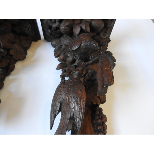 72 - A PAIR OF 19TH CENTURY CARVED FRUITWOOD CORBELS, each depicting two birds amongst a cornucopia of fr... 