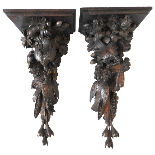 72 - A PAIR OF 19TH CENTURY CARVED FRUITWOOD CORBELS, each depicting two birds amongst a cornucopia of fr... 