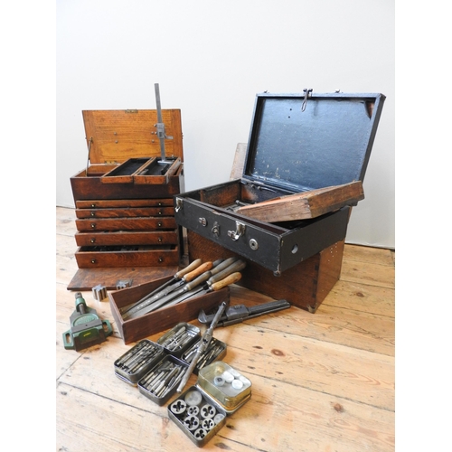 147 - A VINTAGE OAK TOOLMAKER'S CHEST, with five graduated drawers and lift-top, the chest full with vario... 