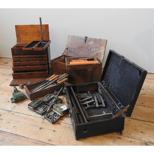 147 - A VINTAGE OAK TOOLMAKER'S CHEST, with five graduated drawers and lift-top, the chest full with vario... 