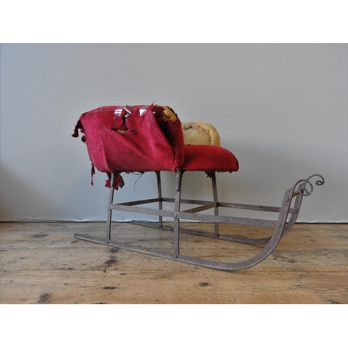 296 - A 19TH CENTURY CHILD'S SLEIGH, wrought-iron frame, partially upholstered and covered(45cm high, 35cm... 