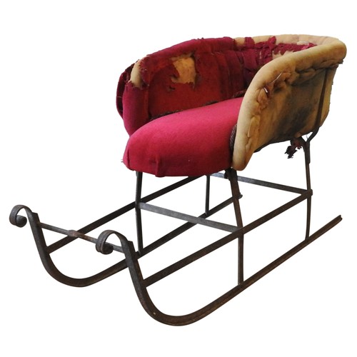 296 - A 19TH CENTURY CHILD'S SLEIGH, wrought-iron frame, partially upholstered and covered(45cm high, 35cm... 