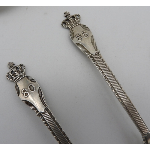 512 - A PAIR OF DANISH SILVER CROWN DECORATED SPOONS AND AN IRISH SILVER BASTING SPOON, along with a silve... 