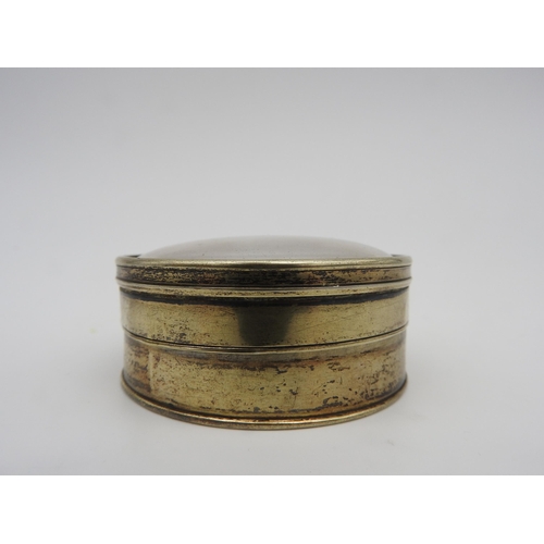 431 - A 19TH CENTURY CIRCULAR WHITE METAL SNUFF POT, the glazed lid inset with a gilt metal relief panel d... 