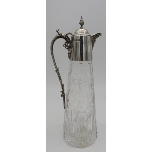 527 - AN ELEGANT SILVER MOUNTED CUT GLASS CLARET JUG, of tapered form with etched vine decoration to the b... 