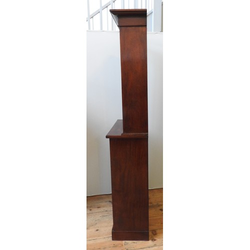 65 - AN ELEGANT 19TH CENTURY MAHOGANY BOOKCASE ON CABINET, circa 1850, simplistic slender form, comprised... 