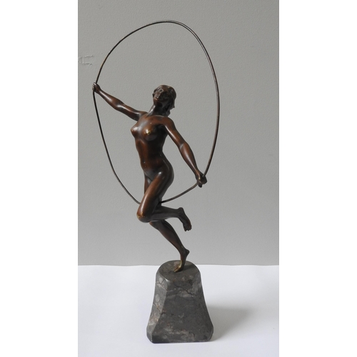 322 - AN ART DECO CAST BRONZE FIGURINE OF NUDE, in gymnastic pose with hoop, on a tapering marble plinth b... 