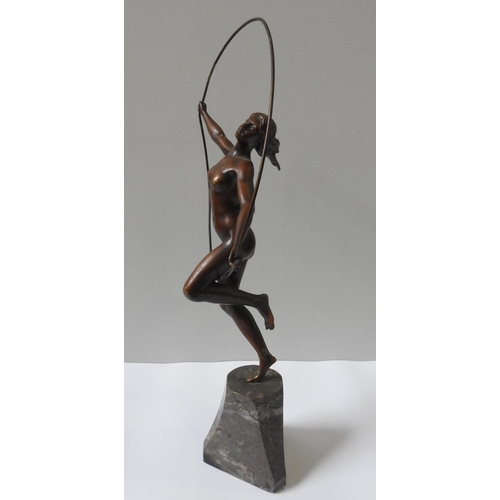 322 - AN ART DECO CAST BRONZE FIGURINE OF NUDE, in gymnastic pose with hoop, on a tapering marble plinth b... 