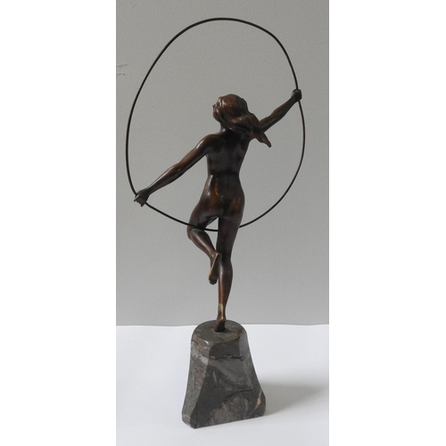 322 - AN ART DECO CAST BRONZE FIGURINE OF NUDE, in gymnastic pose with hoop, on a tapering marble plinth b... 