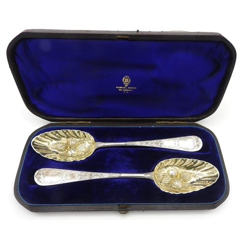 505 - A PAIR OF 18TH CENTURY SILVER BERRY SPOONS, with bright cut decorated handles, rubbed indistinct hal... 