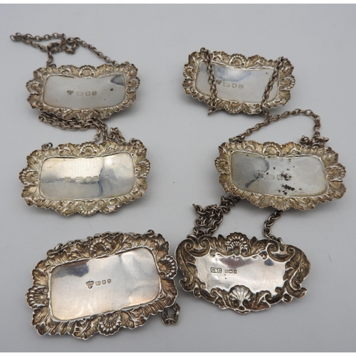 475 - A SET OF FOUR SILVER DECANTER LABELS AND TWO OTHER DECANTER LABELS, all with repousse rococo style b... 