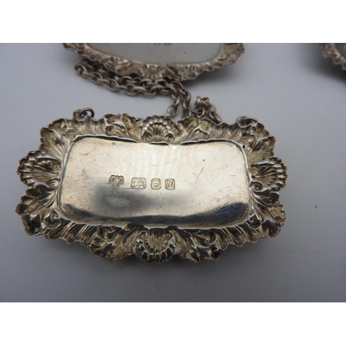 475 - A SET OF FOUR SILVER DECANTER LABELS AND TWO OTHER DECANTER LABELS, all with repousse rococo style b... 