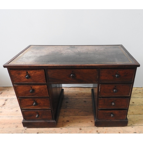 69 - A 19TH CENTURY MAHOGANY WRITING DESK, with leather inset top, a long frieze drawer flanked by two ba... 