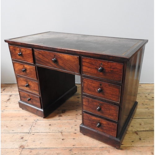 69 - A 19TH CENTURY MAHOGANY WRITING DESK, with leather inset top, a long frieze drawer flanked by two ba... 