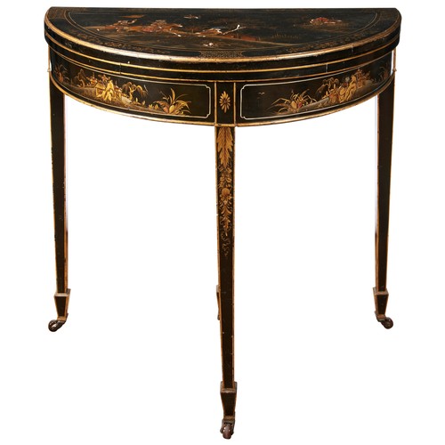 74 - A JAPANNED DEMI LUNE CARD TABLE, the top folding over to reveal a baize lined interior, gilt chinose... 