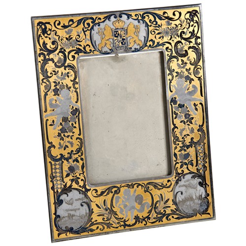 583 - A SWEDISH STEEL EASEL PHOTOGRAPH FRAME with the Swedish coat of arms over putti and floral decorated... 