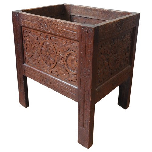 38A - A 19TH CENTURY CARVED OAK PLANTER, simplistic form, with scroll foliate and roundel carved panels, r... 