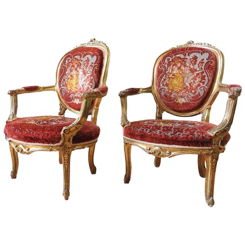 48 - A PAIR OF LOUIS XI-STYLE GILT WOOD FAUTEILS, 20th century, covered in a burgundy damask material dep... 