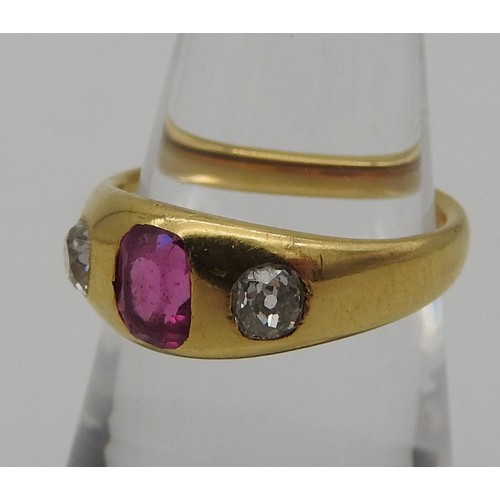 461 - A YELLOW METAL LADIES RING, early 20th century with a central pink stone flanked by two diamonds. To... 