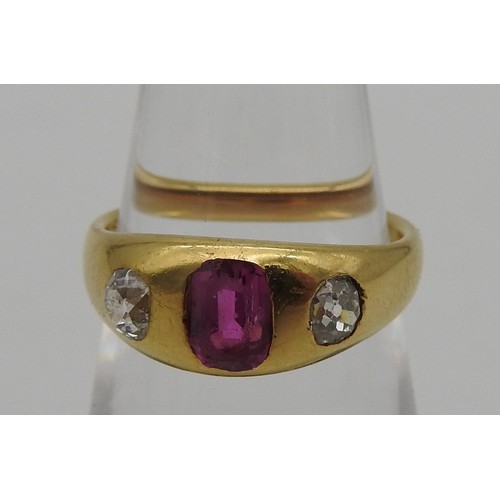 461 - A YELLOW METAL LADIES RING, early 20th century with a central pink stone flanked by two diamonds. To... 