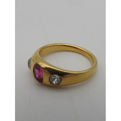 461 - A YELLOW METAL LADIES RING, early 20th century with a central pink stone flanked by two diamonds. To... 