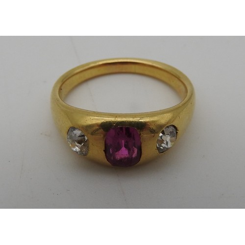 461 - A YELLOW METAL LADIES RING, early 20th century with a central pink stone flanked by two diamonds. To... 