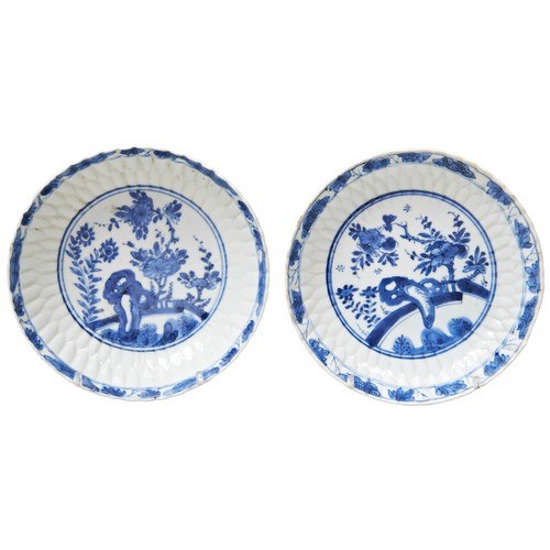 262 - PAIR OF SMALL LOTUS-PETAL MOULDED BLUE AND WHITE DISHESKANGXI PERIOD (1662-1722)each painted in tone... 