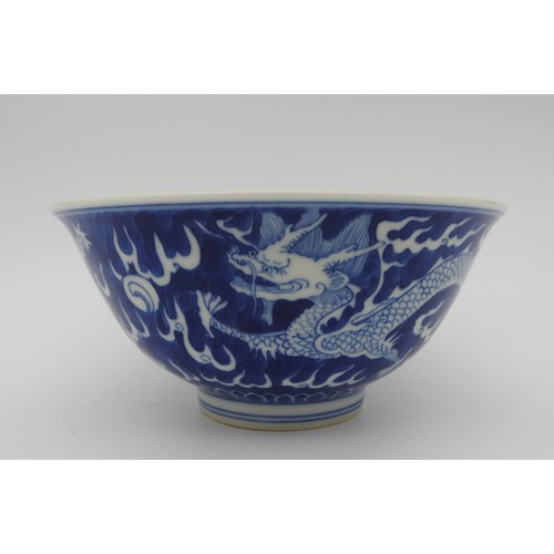 245 - A CHINESE BLUE & WHITE 'DRAGON' BOWL., 20th century, with apocryphal Kangxi six character, 16.5 ... 