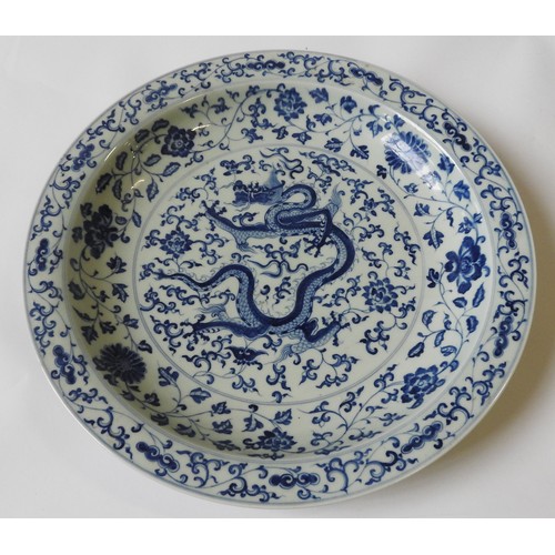 246 - A CHINESE BLUE & WHITE 'DRAGON' CHARGER, 20th century, with an apocryphal Chenghua mark, 41 cm d... 