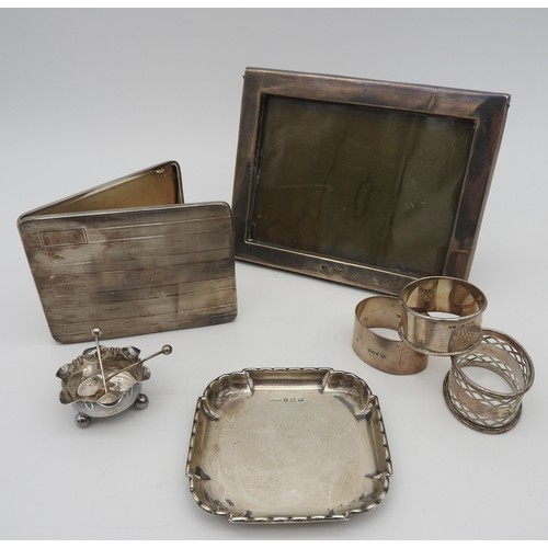 421 - A SILVER CIGARETTE CASE, PICTURE FRAME AND RING DISH, along with three silver napkin rings and a sil... 