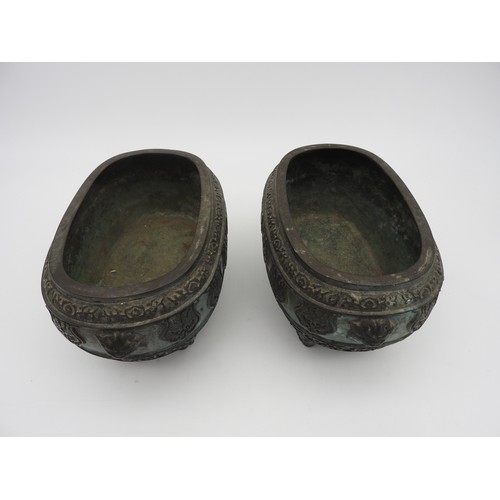 231 - A PAIR OF CHINESE BRONZE QUADRIPOD INCENSE BURNERS, elongated ovoid form, decorated with relief band... 