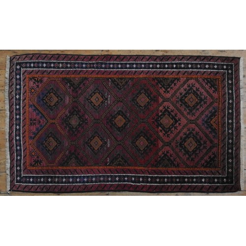 65 - A PERSIAN DESIGN RUG, geometric panels on a pink ground201 x 94 cm