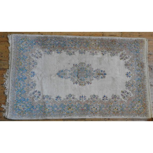 75 - AN INDIAN CARPET, with floral decoration on a cream ground283 x 155 cm