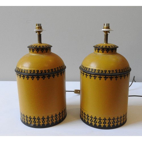 82 - PAIR OF OKA 'BERBER' TABLE LAMPS, cannister form, painted pale gold with border patterns, 45 cm high... 