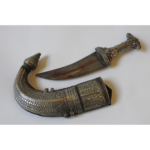 108 - AN OMANI SAIDI KHANJAR, curved blade with ornate silvered handle and case, 33 cm long