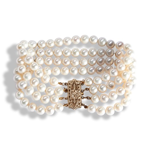 138 - A CULTURED PEARL BRACELETcomposed of of four uniform rows of cultured pearls with with gold spacer b... 