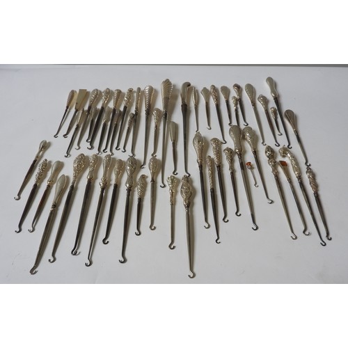 328 - A LARGE COLLECTION OF VICTORIAN AND EDWARDIAN SILVER HANDLED BUTTON HOOKS, including novelty finial ... 