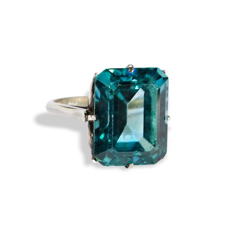 146 - A 20TH CENTURY BLUE ZIRCON RINGthe emerald-cut, cut cornered zircon eight claw to a pierced gallery,... 