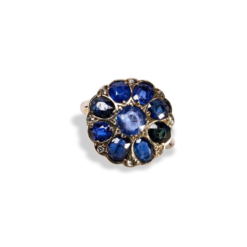 91 - A SAPPHIRE AND DIAMOND CLUSTER RINGthe central claw set, round cut sapphire surrounded eight oval cu... 