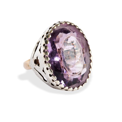 92 - A SINGLE STONE OVAL AMETHYST RINGwith a claw set wit an oval amethyst set in silver on a later gold ... 