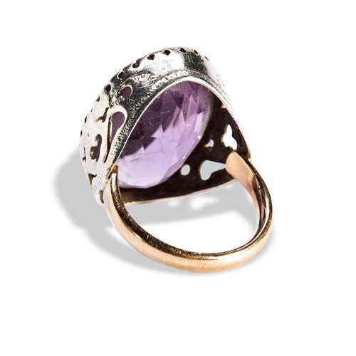 92 - A SINGLE STONE OVAL AMETHYST RINGwith a claw set wit an oval amethyst set in silver on a later gold ... 